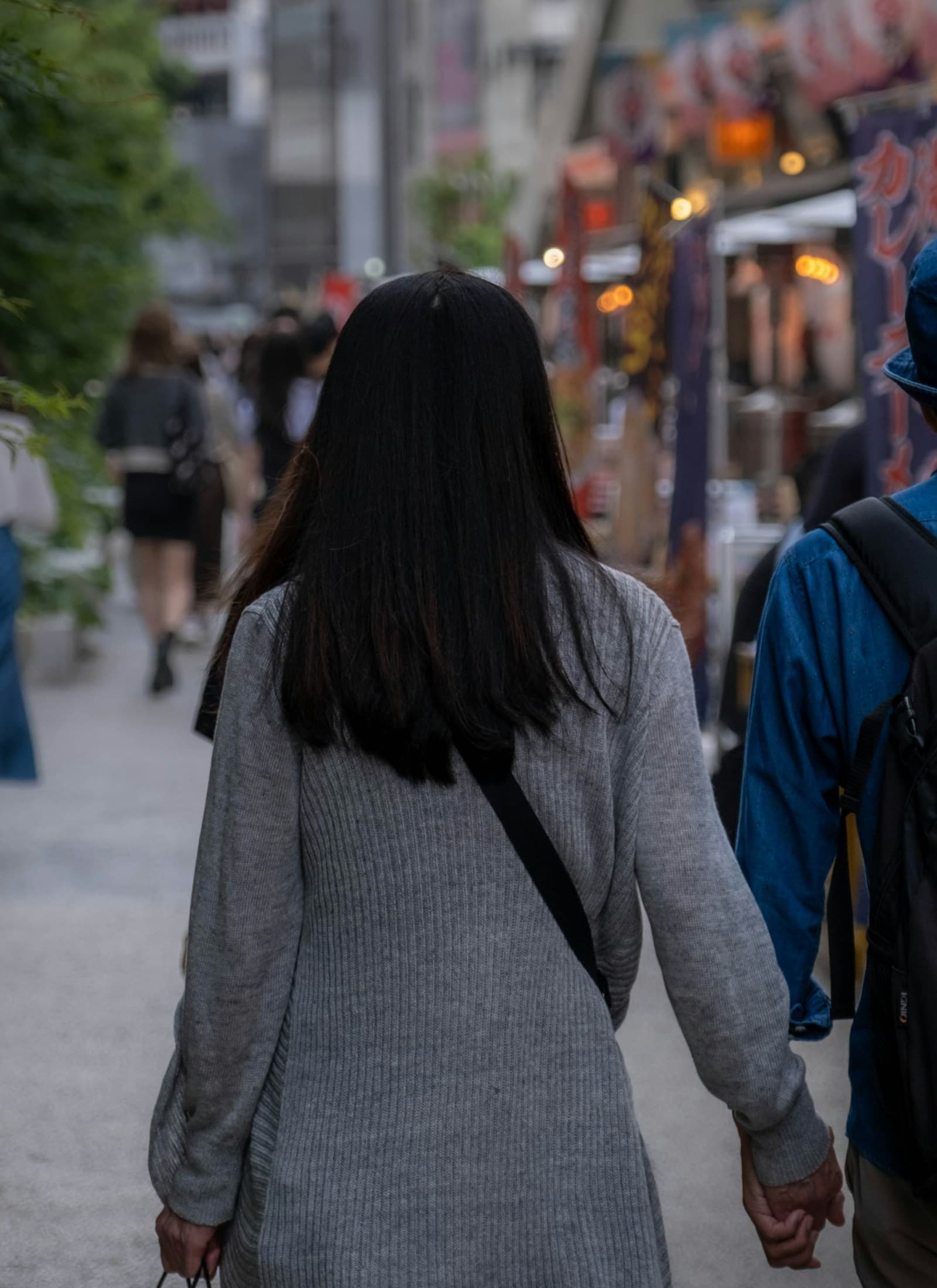 Couple walking hand in hand along a street