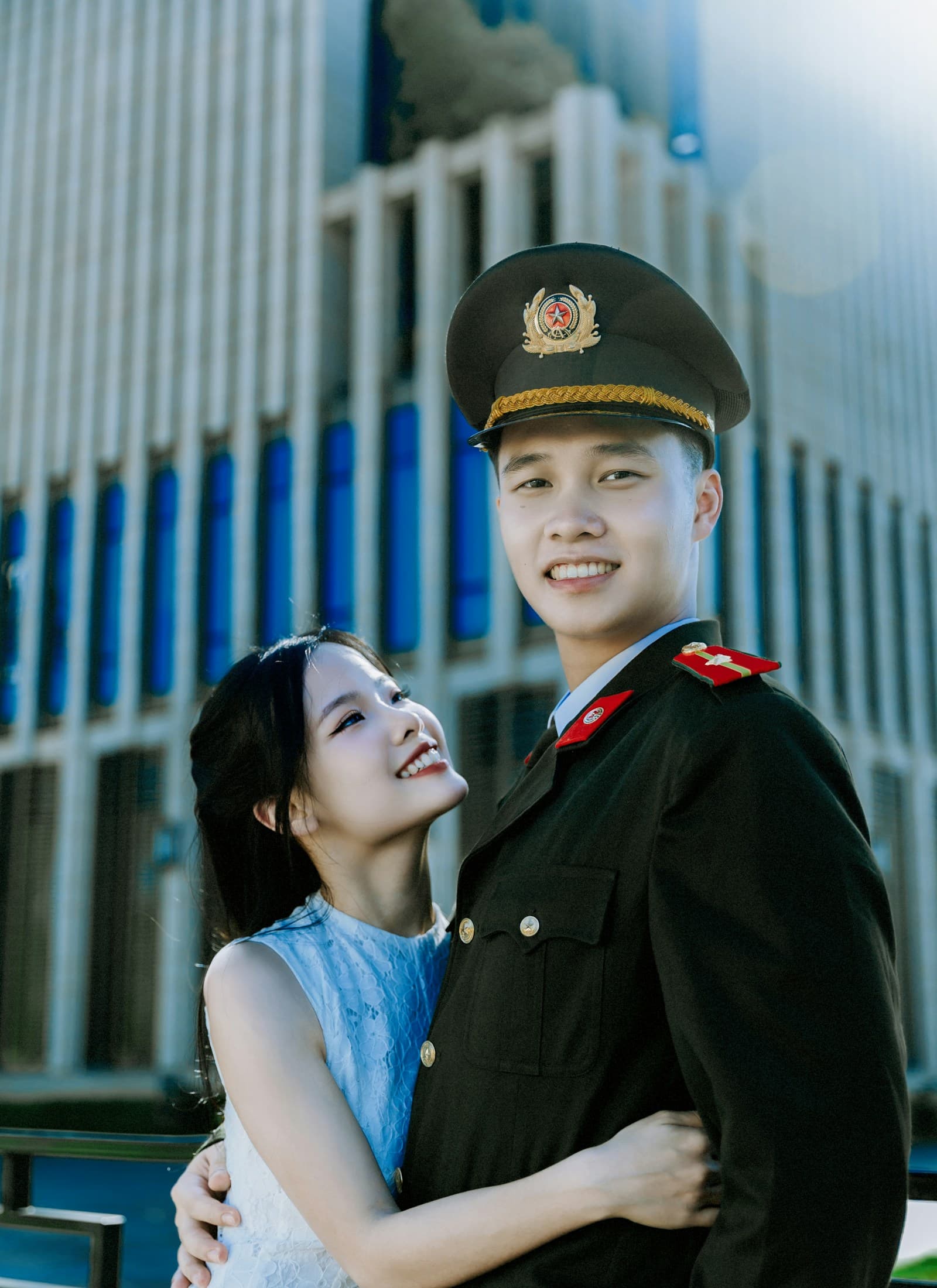 Couple posing near a modern building