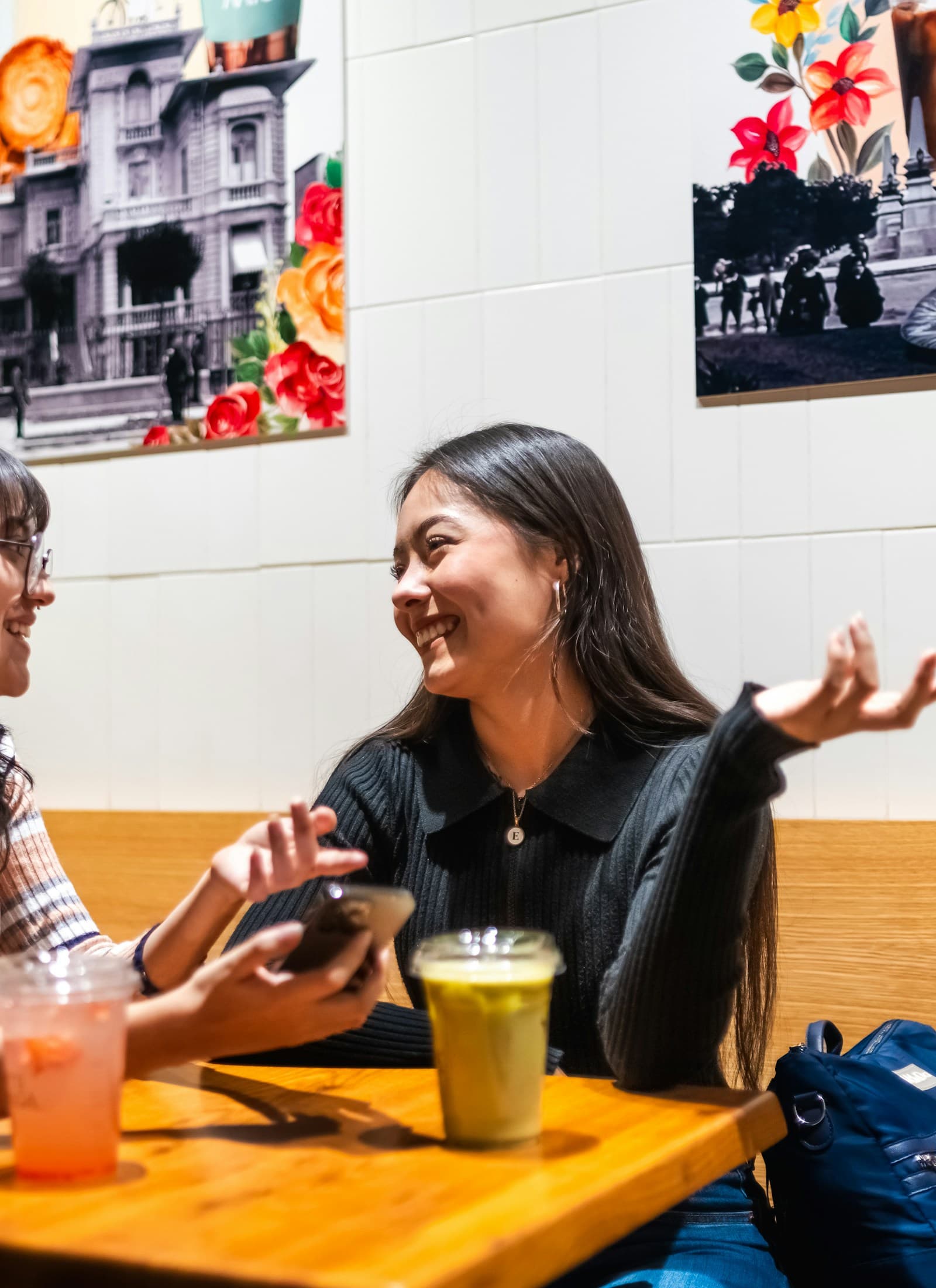 Two women chatting over drinks in a cafe